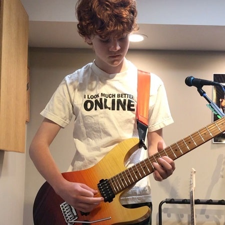 A picture of Kyle Harrison Breitkopf playing electric guitar.